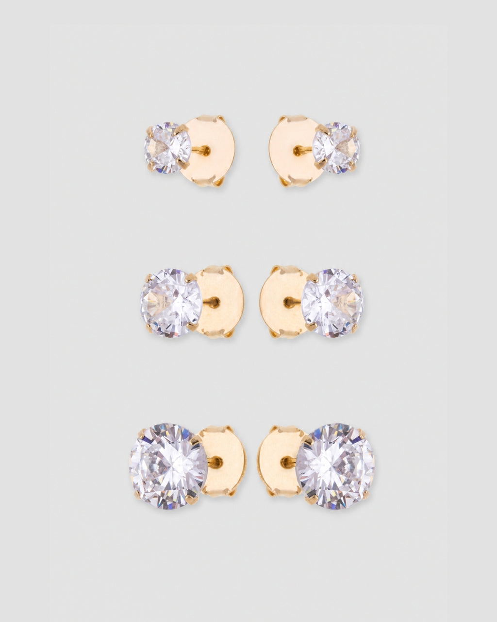 Trio brinco ponto de luz zircônia com base dourada em três tamanhos: 1 cm, 0,7 cm e 0,5 cm — semijoia feminina Papoula